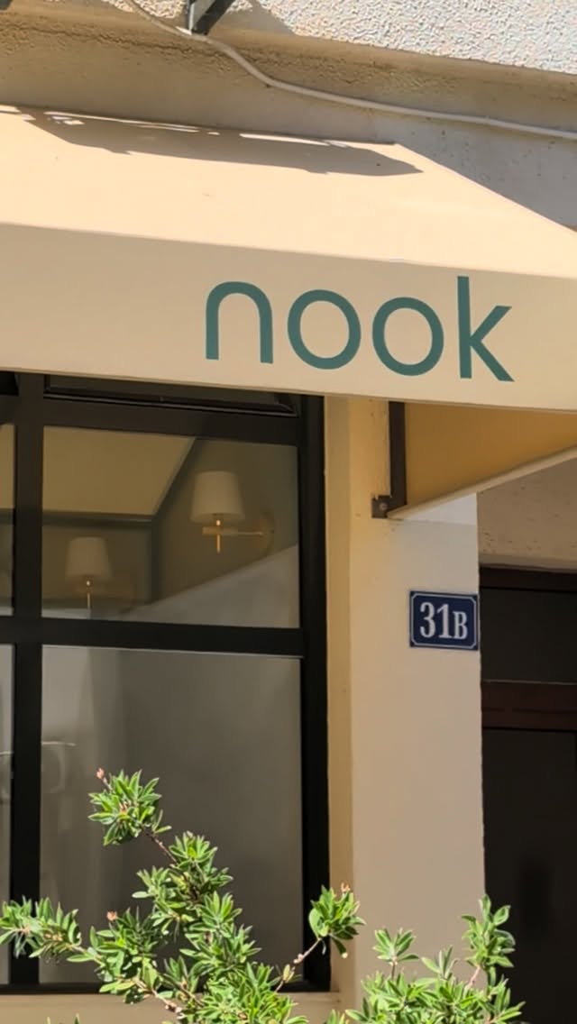 The cream awning with the nook name above the window, beside the house number 31B.