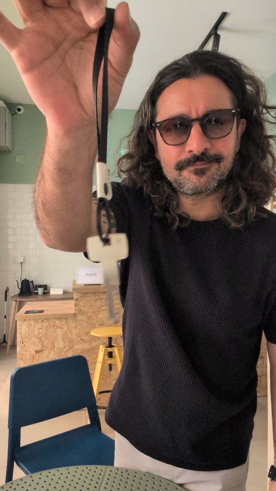 A hand holding up the shop keys inside the half-finished room.