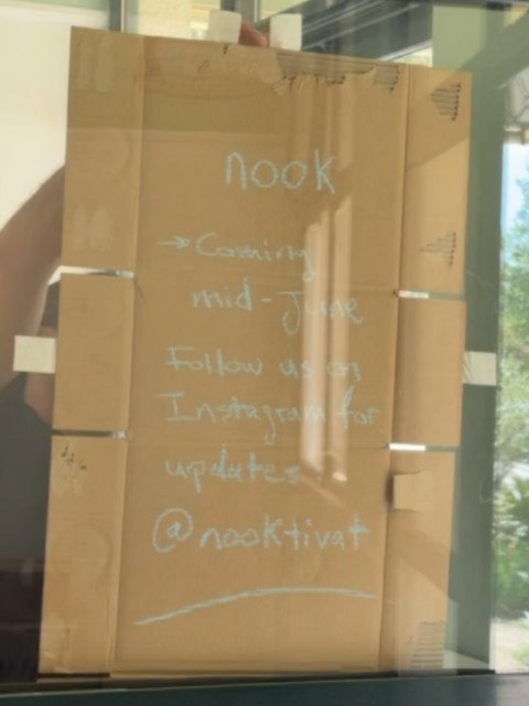 Hand-written cardboard sign taped inside the window: nook, coming mid-June, follow us on Instagram for updates.
